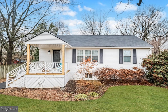 view of front of home with a porch and a front lawn