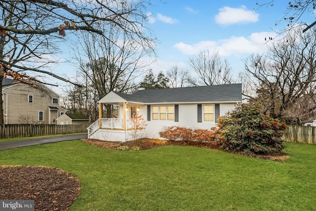 view of front of house featuring a front lawn and covered porch