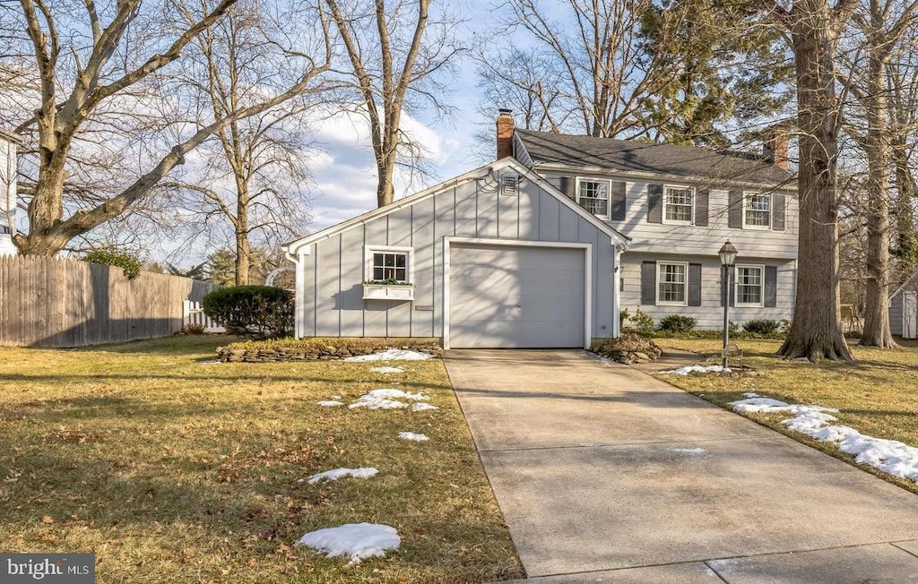 view of front of property with a garage and a front yard