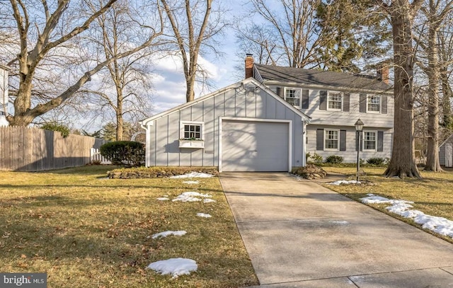 view of front of property with a garage and a front yard