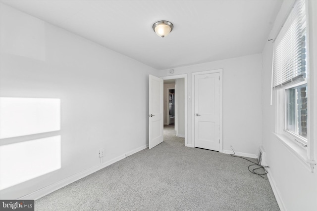 unfurnished bedroom with light colored carpet