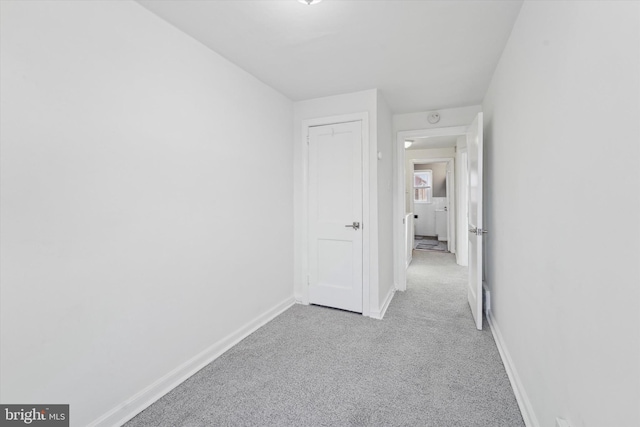 hallway with light colored carpet