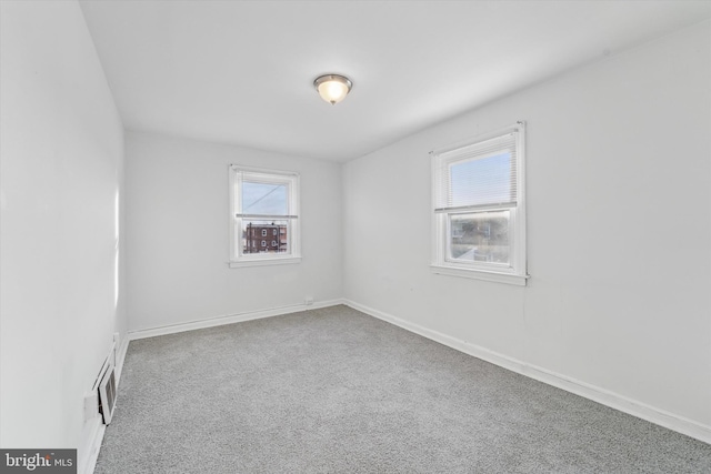 carpeted empty room with a healthy amount of sunlight