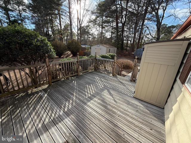 wooden deck featuring a storage shed