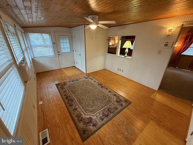 interior space featuring wooden ceiling, light hardwood / wood-style floors, and ceiling fan