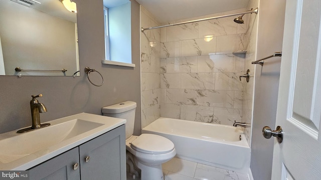 full bathroom featuring tiled shower / bath combo, toilet, and vanity