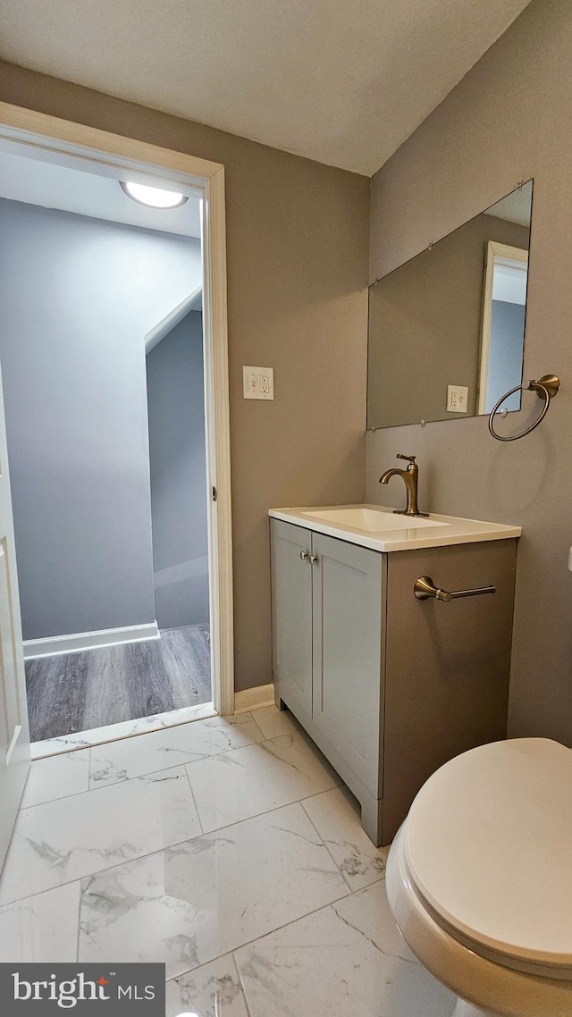 bathroom featuring toilet and vanity