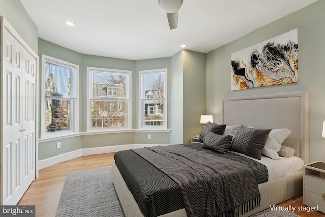 bedroom featuring a closet, ceiling fan, and light hardwood / wood-style flooring