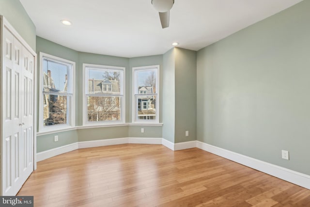 empty room featuring ceiling fan and light hardwood / wood-style flooring