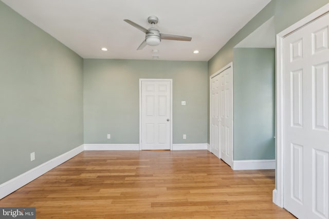 unfurnished bedroom with ceiling fan and light wood-type flooring