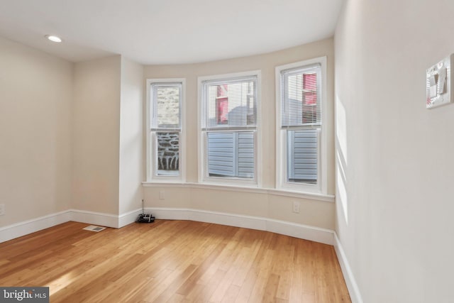 unfurnished room with light hardwood / wood-style floors