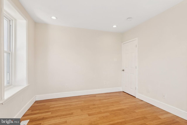 unfurnished room with light wood-type flooring