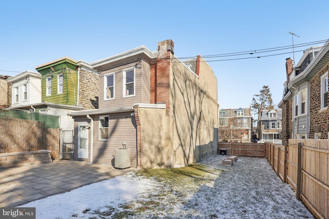 rear view of property with a patio area and central AC