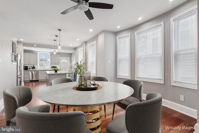 dining area with sink and dark wood-type flooring