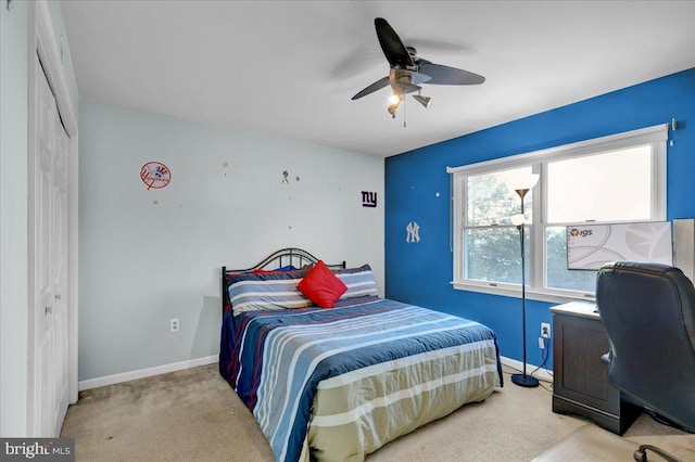 bedroom featuring ceiling fan, light colored carpet, and a closet