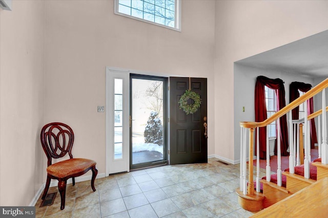 foyer entrance featuring a towering ceiling