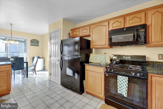 kitchen featuring black appliances, an inviting chandelier, hanging light fixtures, light tile patterned floors, and dark stone counters