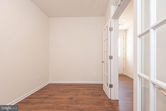 unfurnished room featuring dark hardwood / wood-style floors and french doors