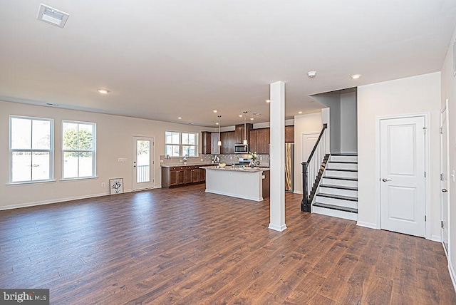 unfurnished living room featuring dark hardwood / wood-style floors