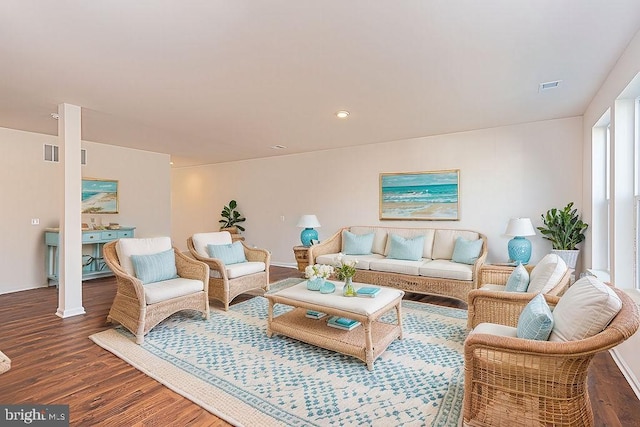 living room featuring a wealth of natural light and dark hardwood / wood-style flooring