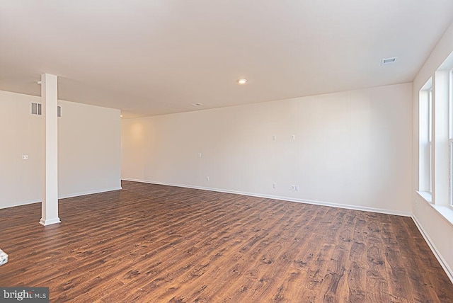 empty room with dark wood-type flooring