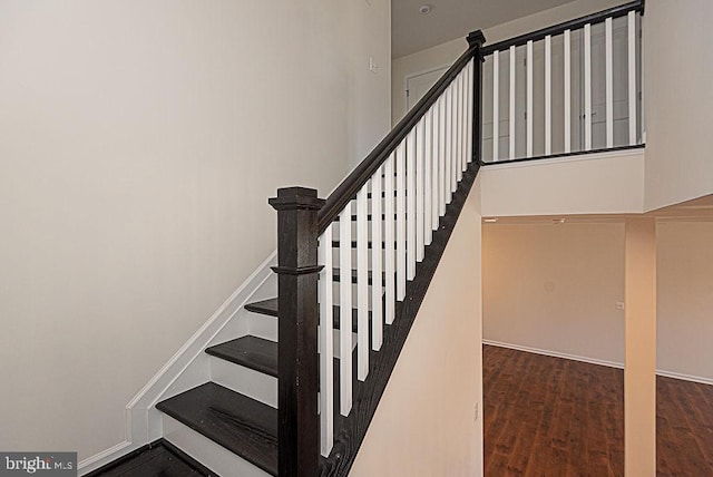 stairway with hardwood / wood-style flooring