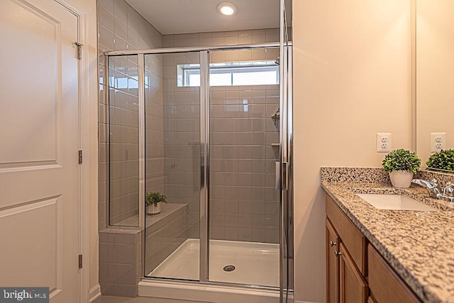 bathroom with an enclosed shower and vanity