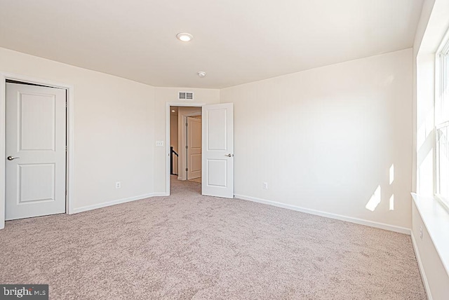 unfurnished room with light colored carpet