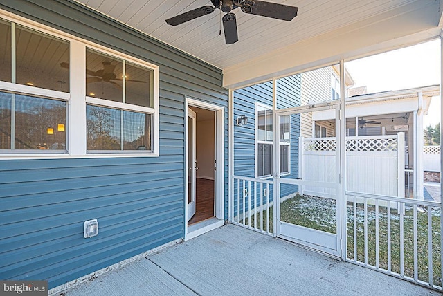 unfurnished sunroom with ceiling fan