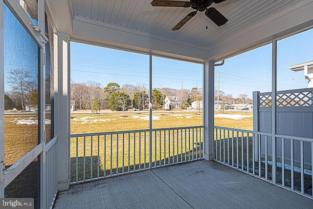 unfurnished sunroom with a wealth of natural light, wooden ceiling, and ceiling fan