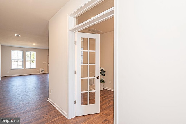 hallway with dark hardwood / wood-style flooring and french doors