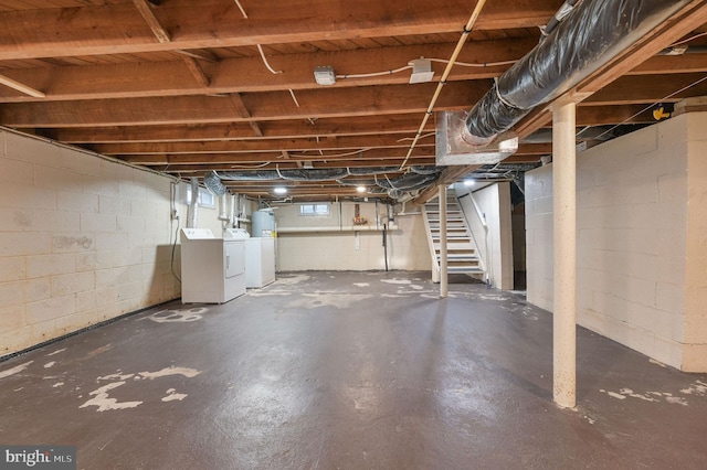 basement featuring washer and clothes dryer and water heater