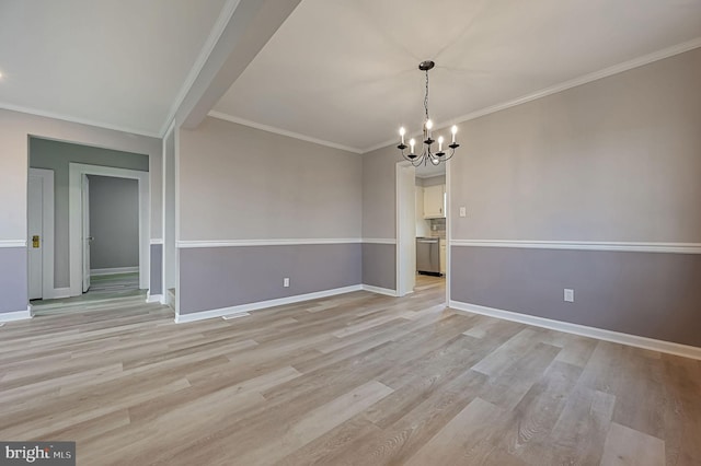 unfurnished dining area featuring crown molding, a chandelier, and light hardwood / wood-style floors