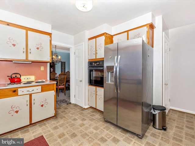 kitchen featuring an inviting chandelier, oven, stainless steel fridge with ice dispenser, and white cabinets