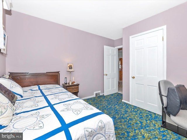 bedroom featuring dark colored carpet