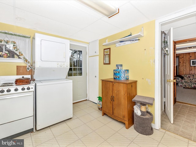 clothes washing area with stacked washer and dryer