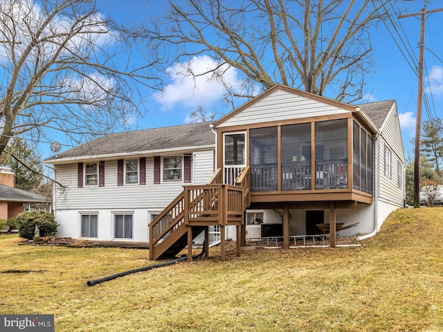 back of property featuring a sunroom and a lawn