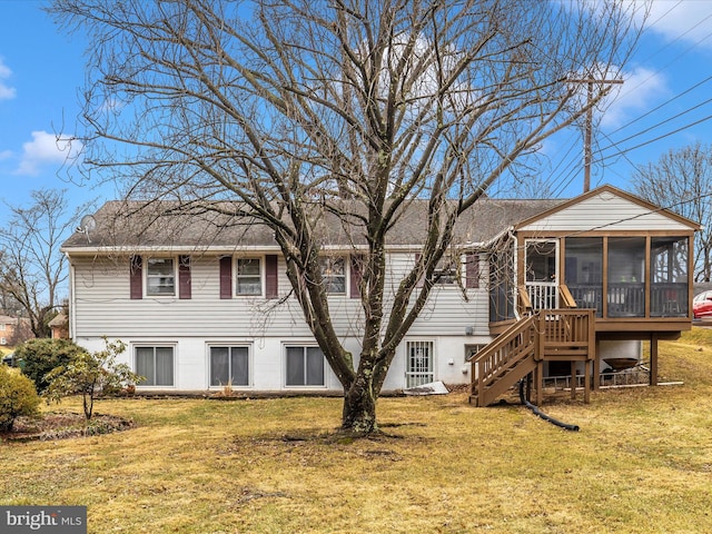 back of house featuring a sunroom and a yard