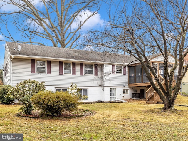 exterior space featuring a sunroom, a front lawn, and central air condition unit