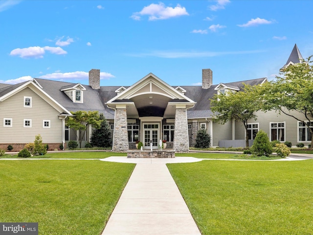 view of front facade featuring a front yard and french doors