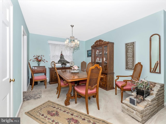 carpeted dining space with a notable chandelier