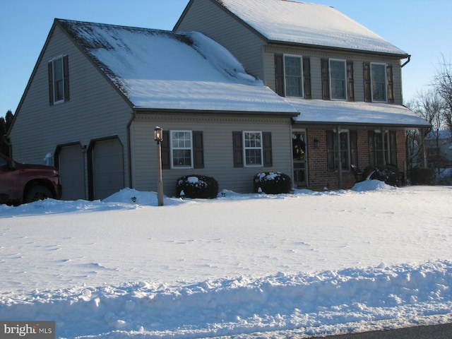 view of front of home with covered porch and a garage