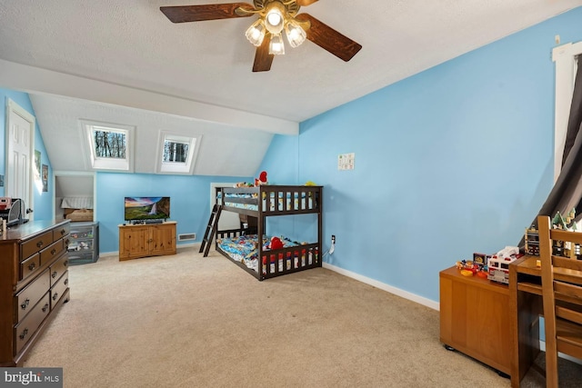 carpeted bedroom featuring a textured ceiling, ceiling fan, and lofted ceiling