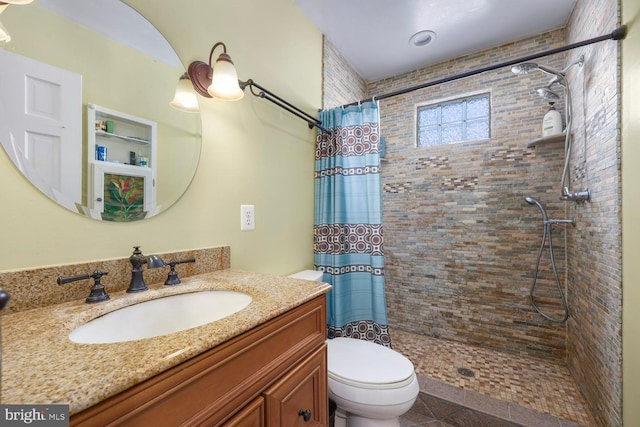 bathroom with toilet, vanity, and a shower with shower curtain