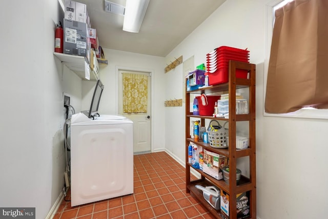 clothes washing area featuring tile patterned flooring and washer / dryer