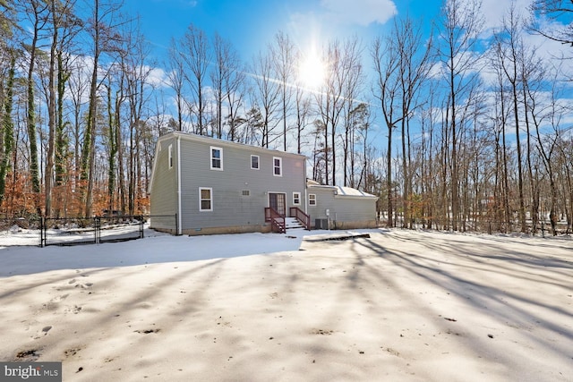 view of snow covered rear of property