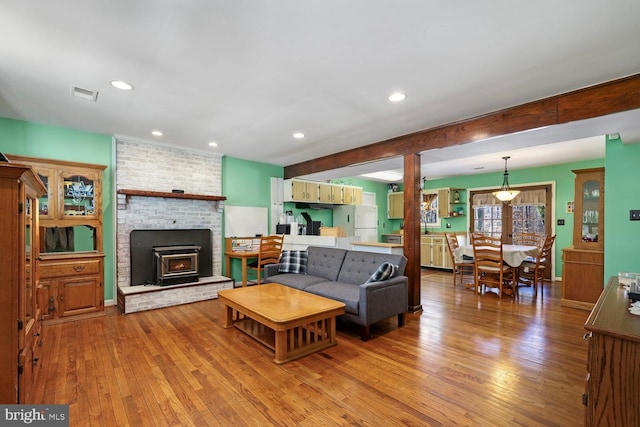 living room with beam ceiling and light hardwood / wood-style flooring