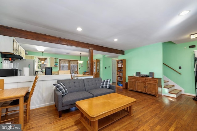 living room featuring beam ceiling and wood-type flooring