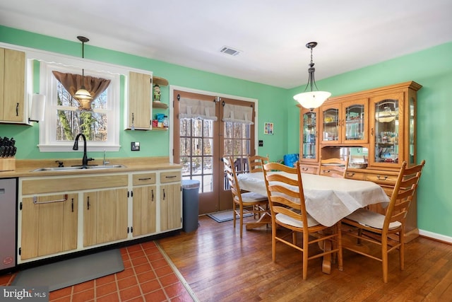 dining space featuring a healthy amount of sunlight, dark hardwood / wood-style floors, and sink