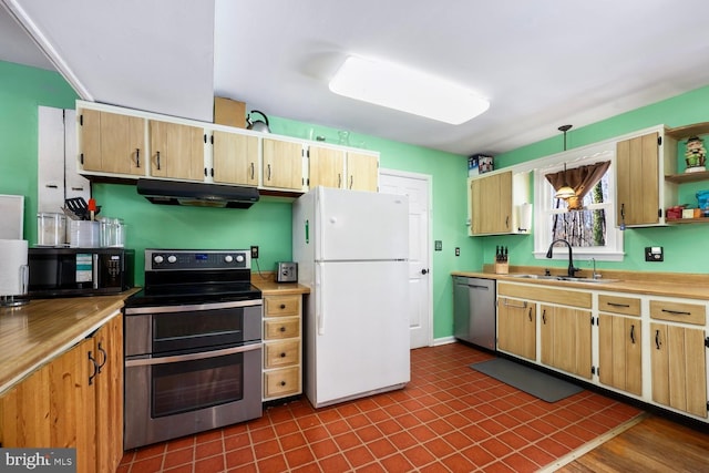 kitchen featuring sink, hanging light fixtures, and appliances with stainless steel finishes